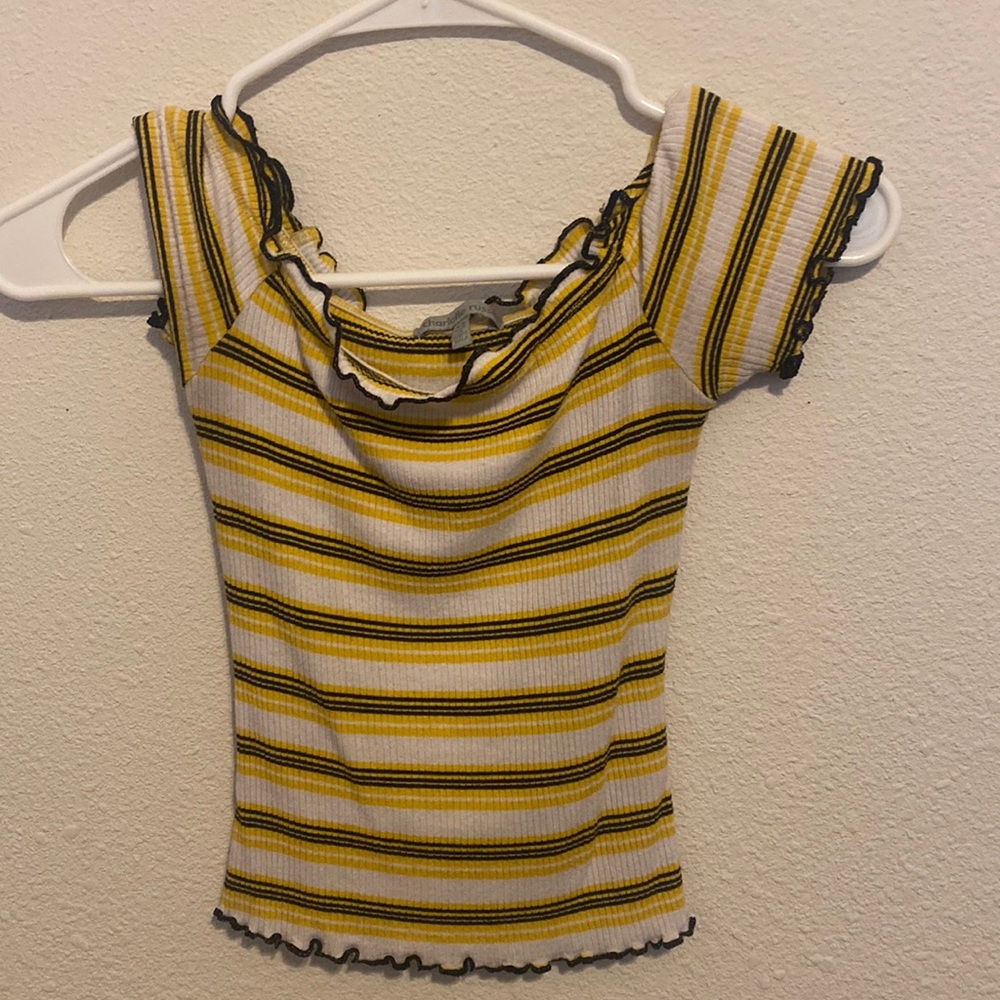 A black, white and yellow off the shoulder crop top